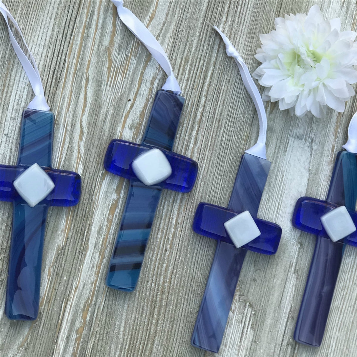 An assortment of blue glass crosses each unique.