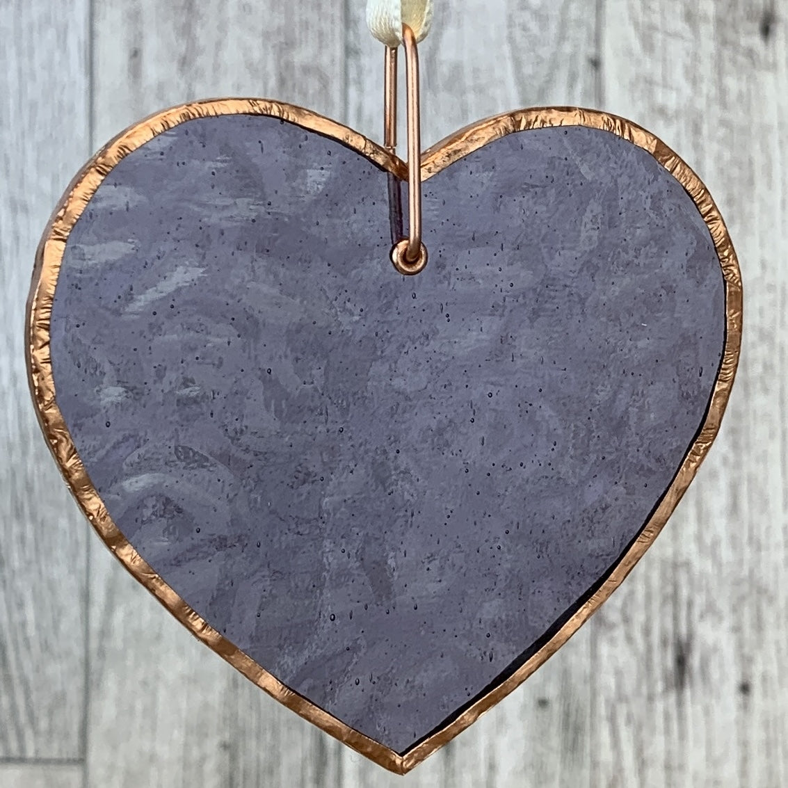 Translucent periwinkle heart with copper edging and off-white satin ribbon for hanging.