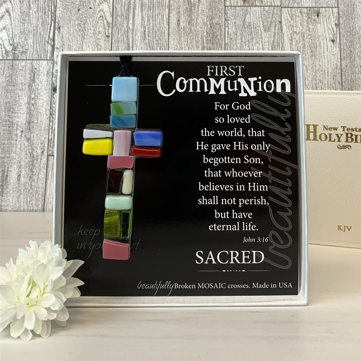 First Communion glass mosaic cross with bible in background.