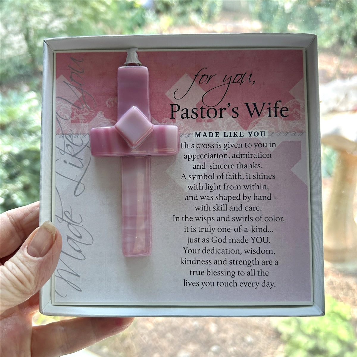 Pastor's Wife cross gift being held in a hand.