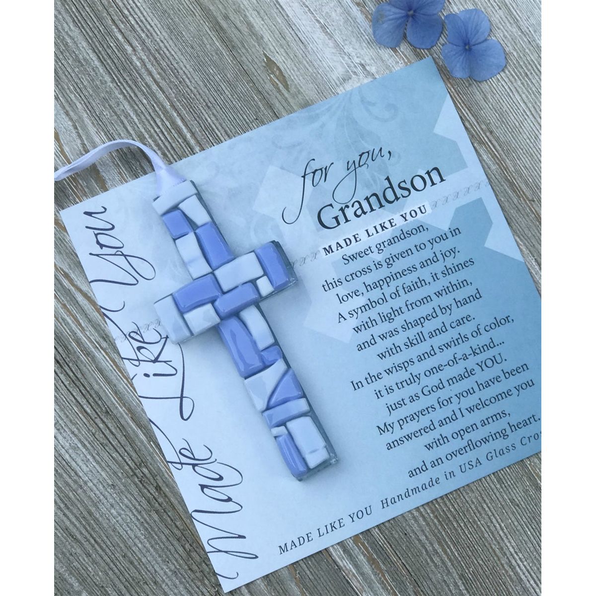 Blue Mosaic cross with shades of blue and white glass lying on the For You, Grandson sentiment artwork.