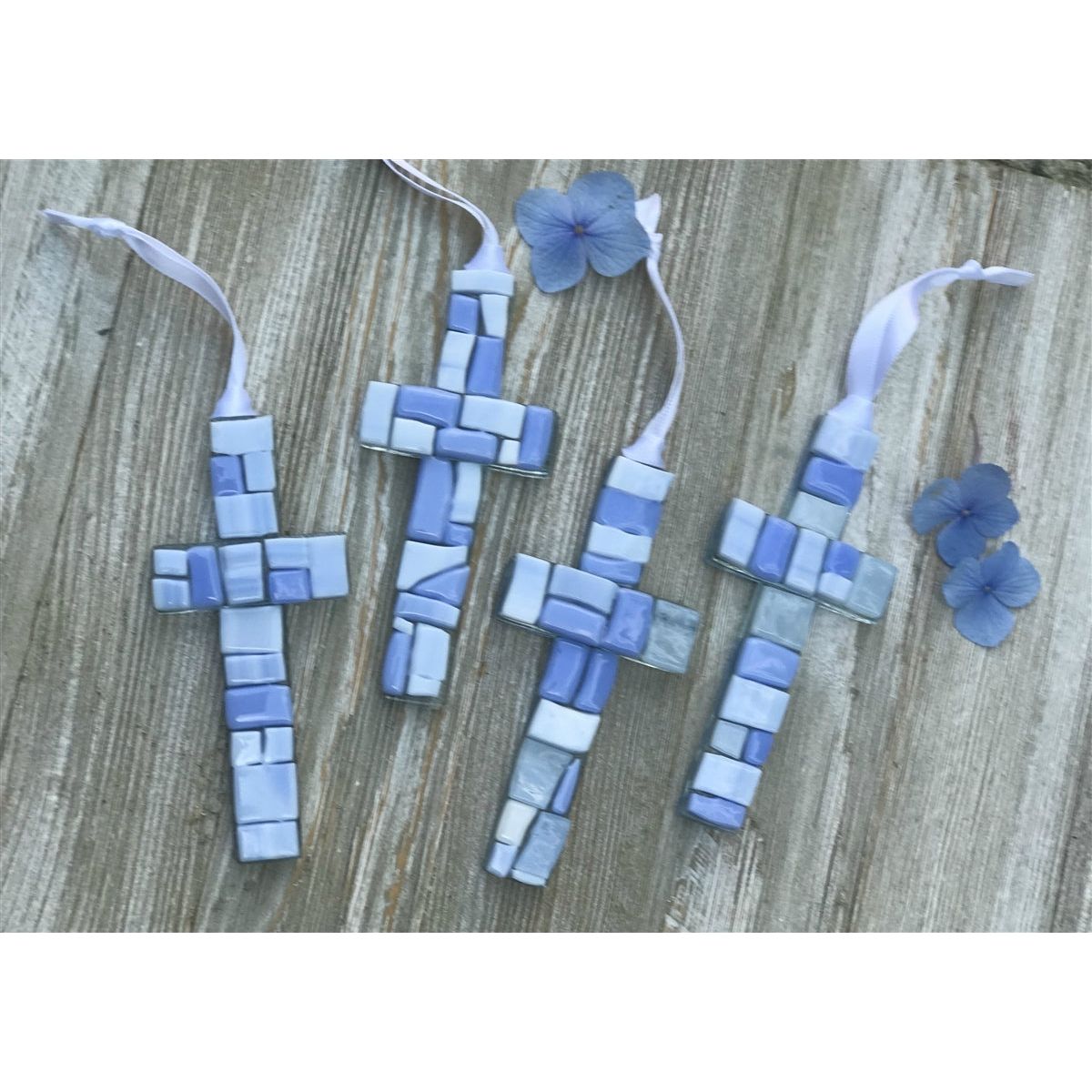 An assortment of blue mosaic crosses with varying shades of blue glass.