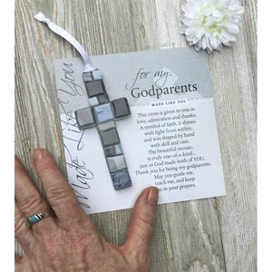 2 of 3:For My Godparents artwork with sentiment and glass cross on a table next to a hand for scale.