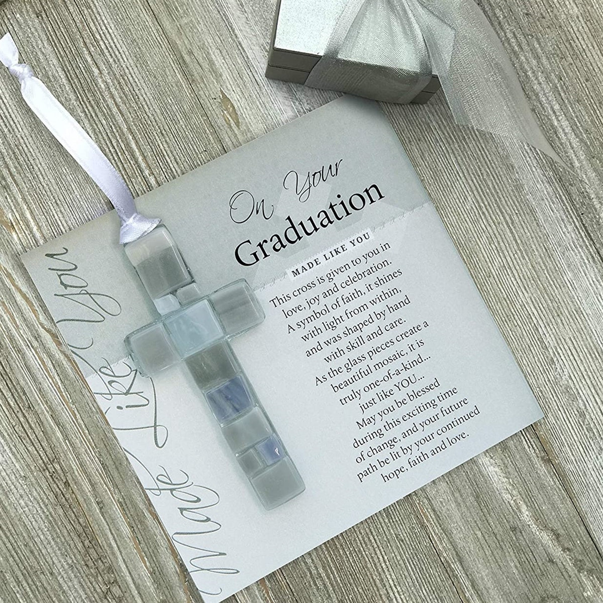 Gray mosaic cross with shades of gray, white, or blue lying on the "On Your Graduation" sentiment artwork.