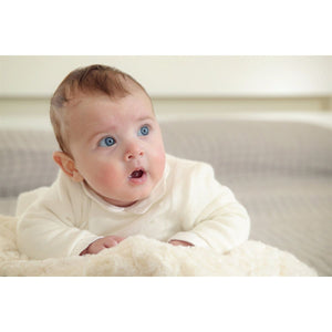 5 of 5:Blue eyed baby with a white outfit on.