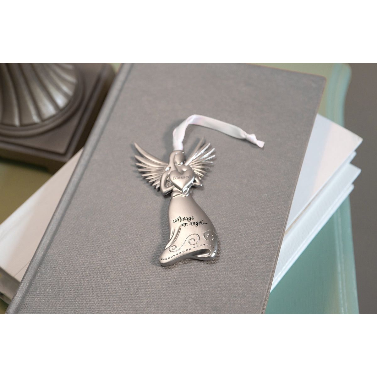 Blessed angel with white satin ribbon for hanging.