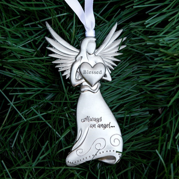 Silver toned metal angel holding a heart with the word "Blessed" in the center and "Always and angel ..." engraved on the angel's skirt