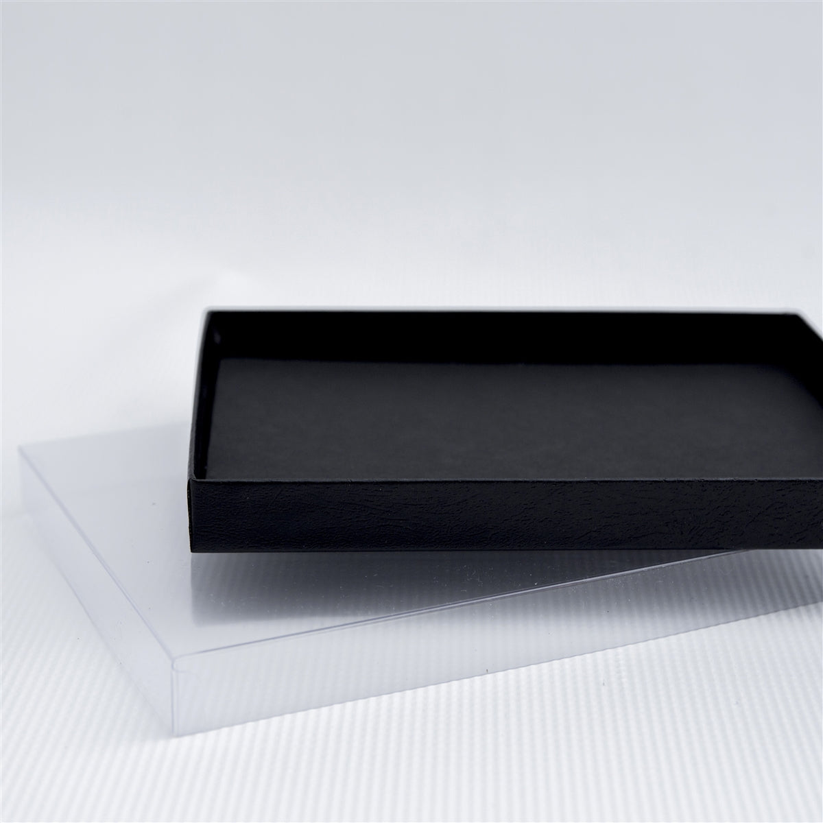 Black leatherette box with clear lid.