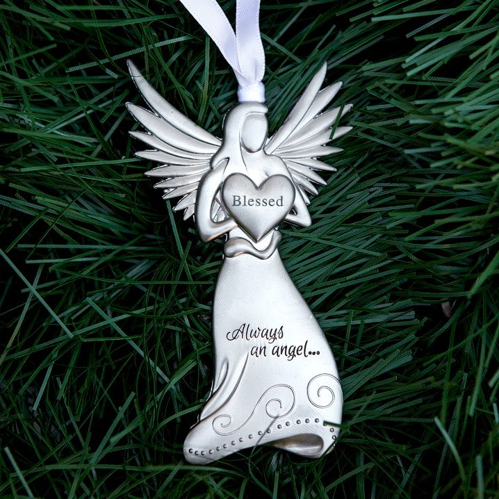 Silver toned metal angel holding a heart with the word &quot;Blessed&quot; in the center and &quot;Always and angel ...&quot; engraved on the angel&#39;s skirt.