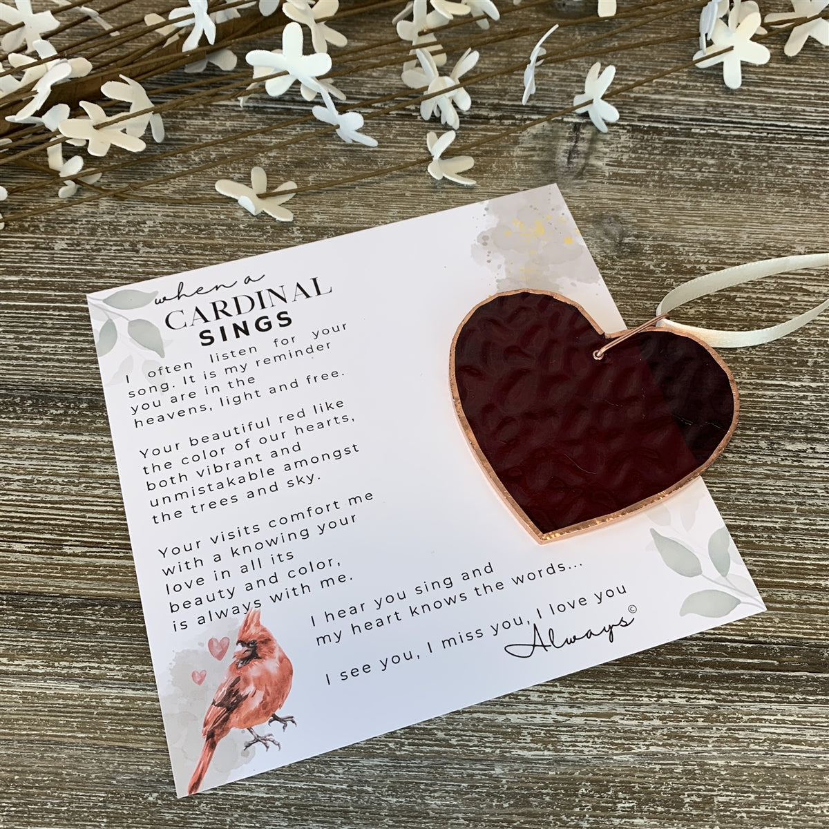 Red stained glass heart with "When a Cardinal Sings" sentiment.