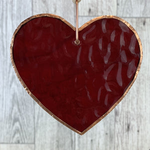 4 of 6:Red glass heart with bubbles, ripples and texture inherent to handmade glass.