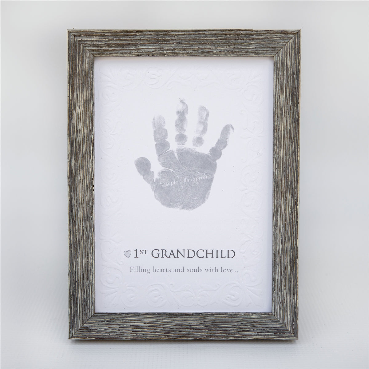 5x7 farmhouse frame with "1st Grandchild" sentiment on embossed cardstock with space for a child's handprint.