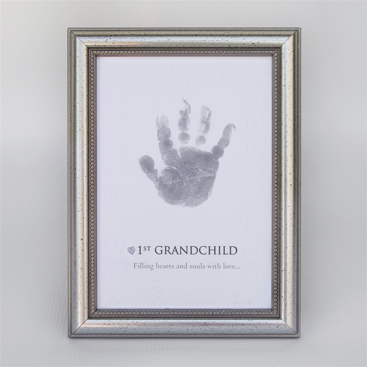 1st Grandchild handprint keepsake in elegant frame in silver with embossed beaded design.
