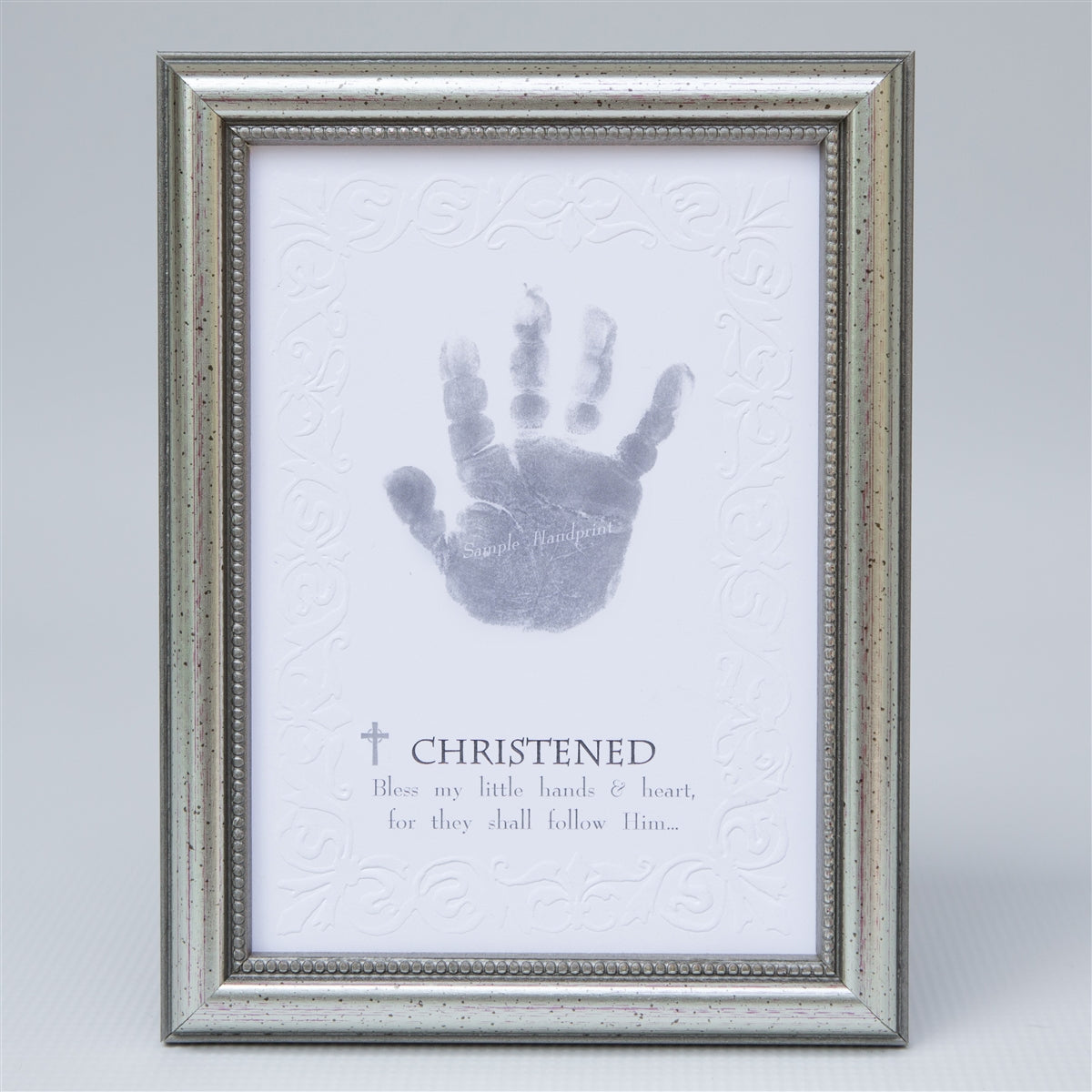Christened handprint keepsake in elegant frame in silver with embossed beaded design.