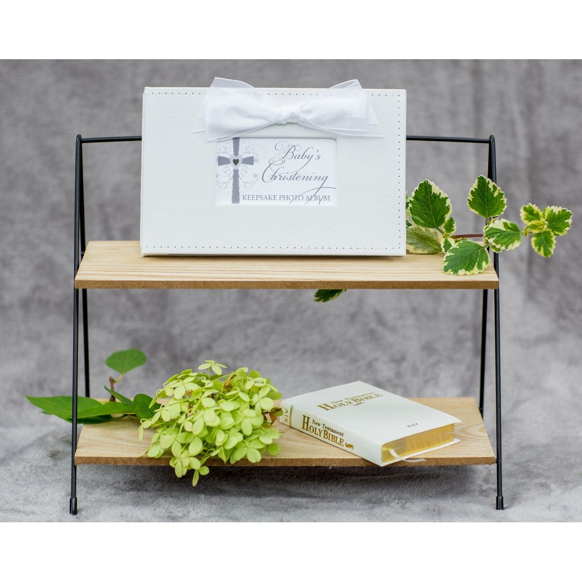 Baby's Christening photo book on bookshelf.