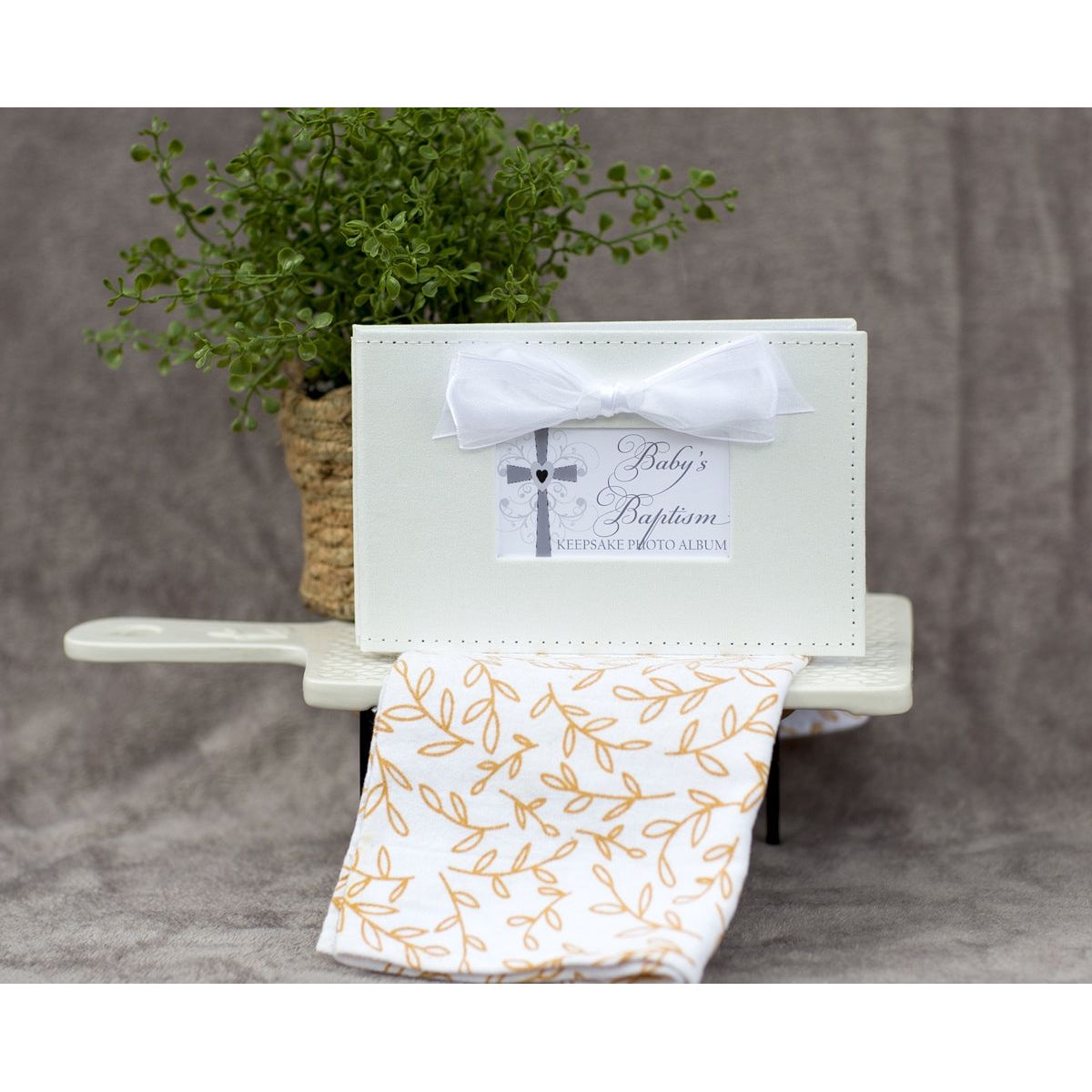 Baby's Baptism photo book in a decorative setting.