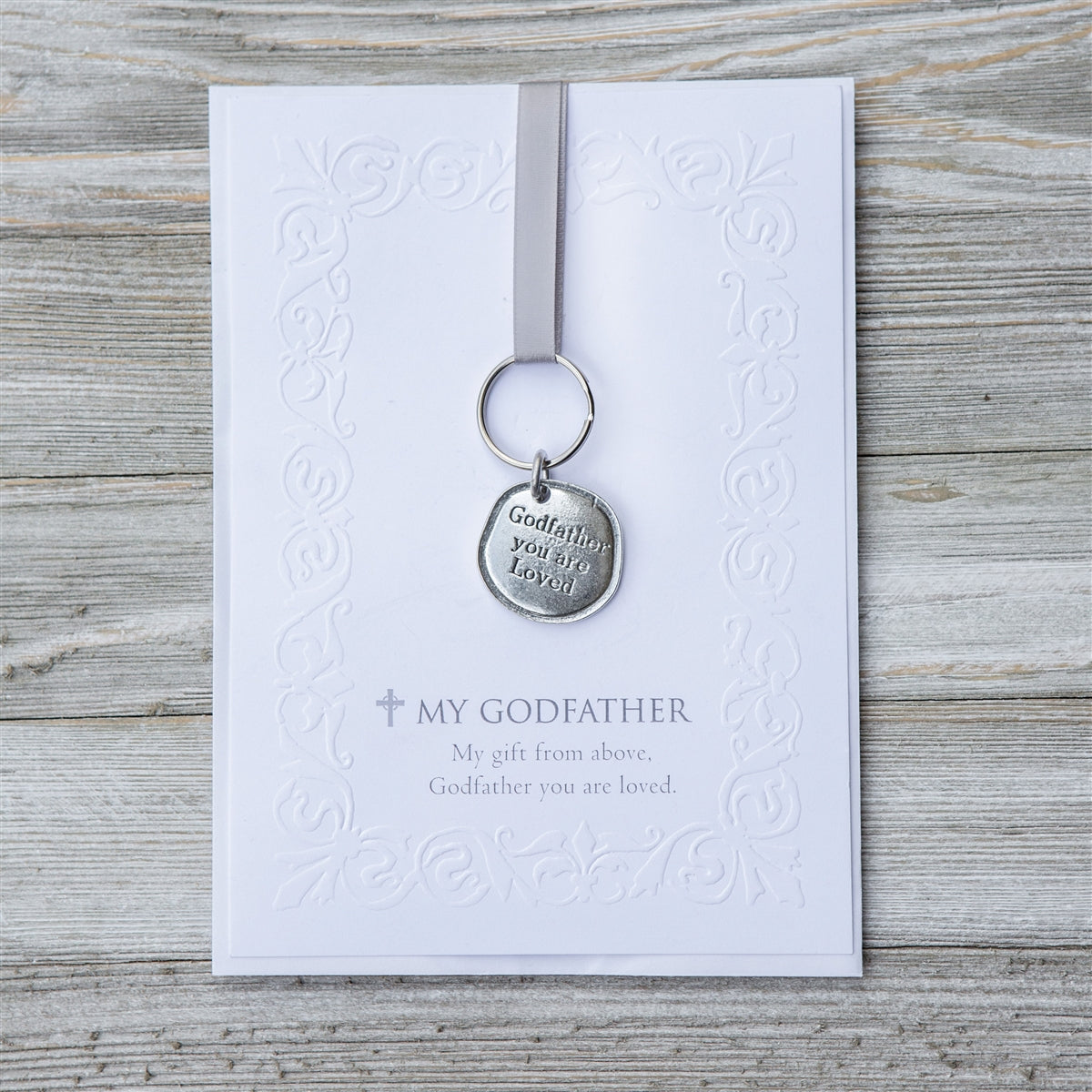 Keychain with pewter coin that says "Godfather you are loved" packaged with an embossed notecard with My Godfather sentiment.