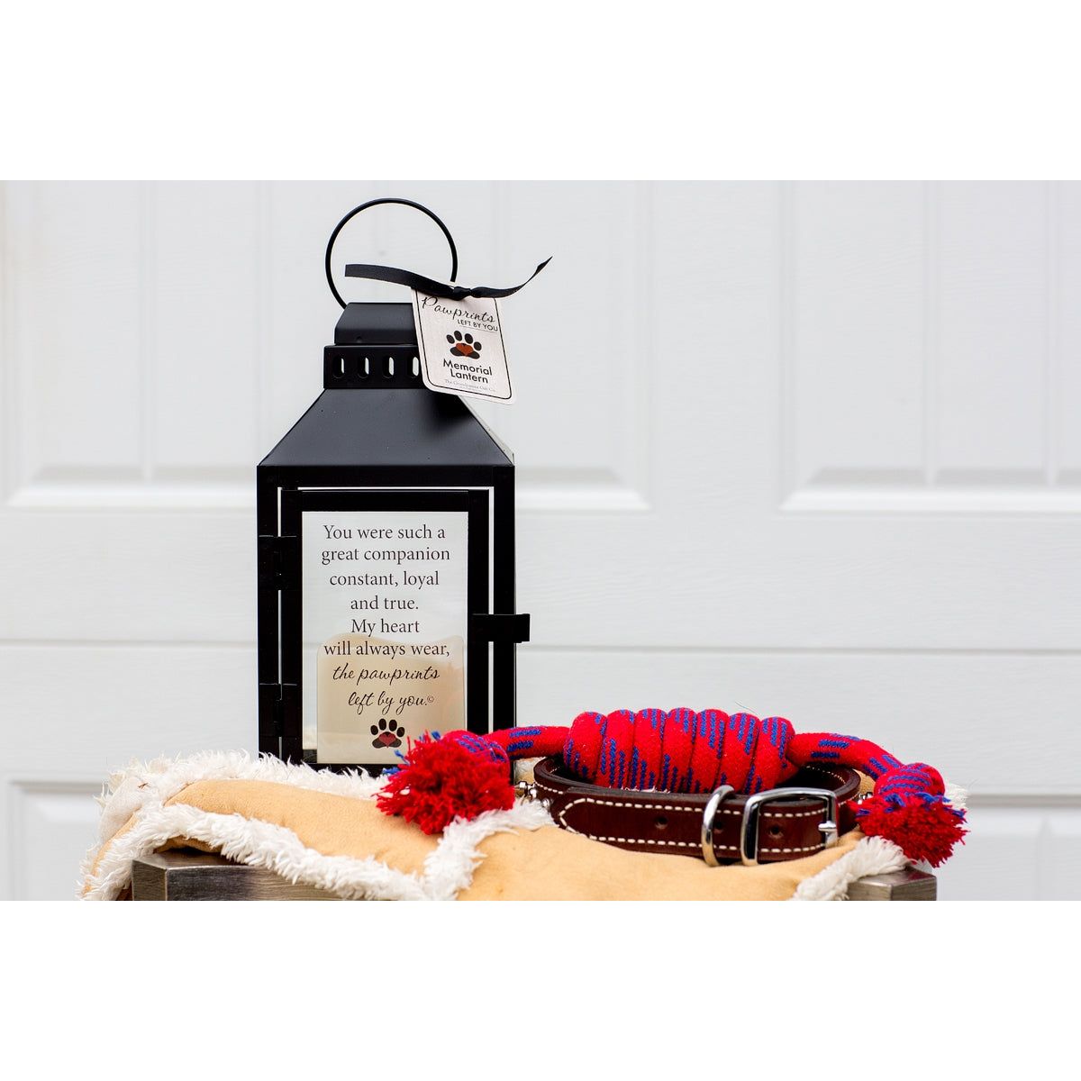 Pet memorial lantern with "Pawprints Left By You" sentiment.