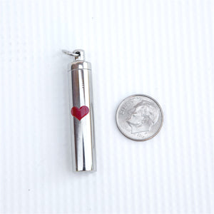2 of 5:Ash vial next to a dime to show size.