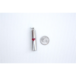 3 of 5:Ash vial next to a dime to show size.