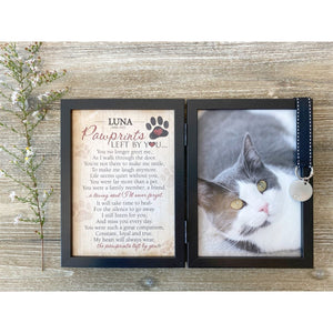 2 of 3:Frame features a black grosgrain ribbon with white stitching that holds a metal tag embossed with a pawprint.