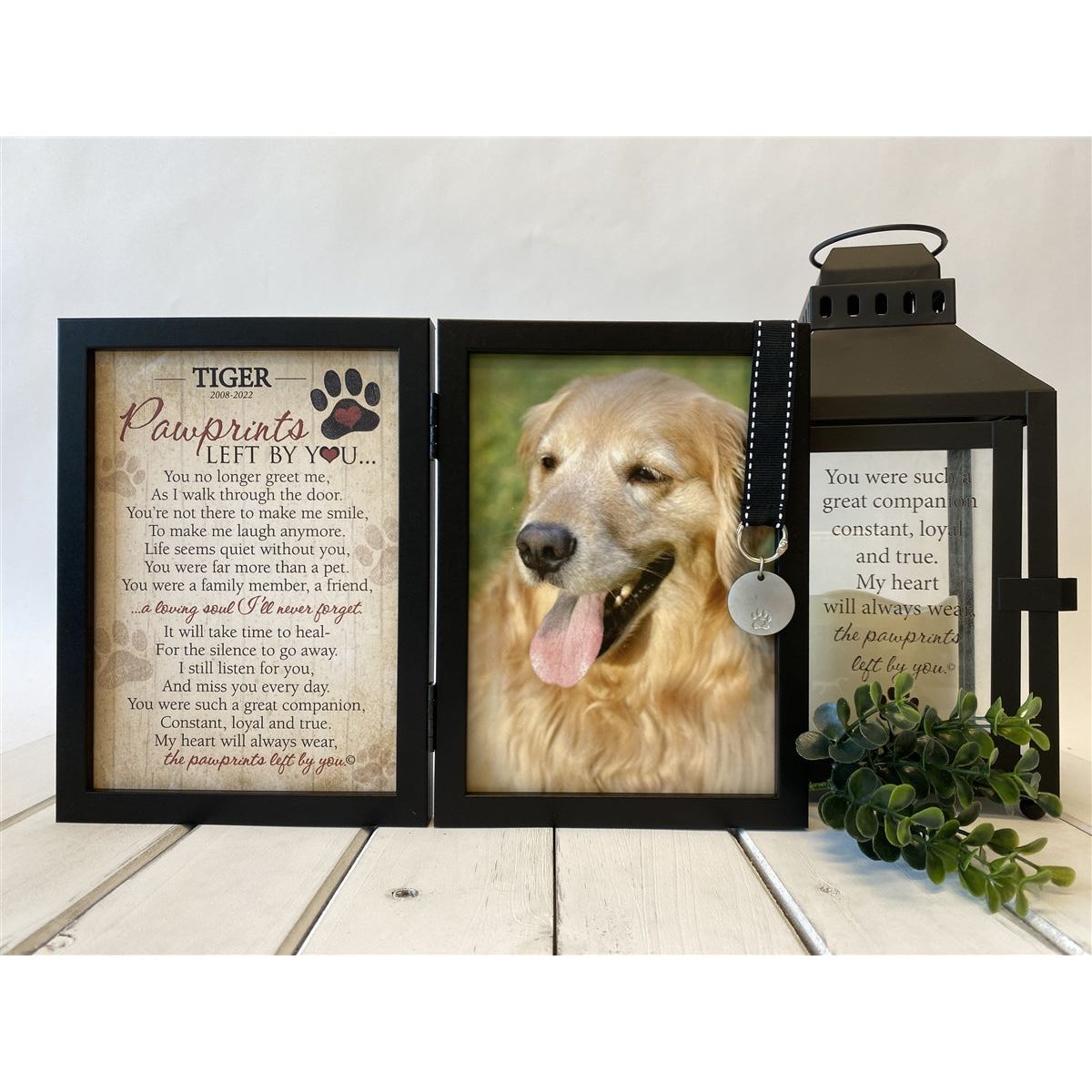 Frame features a black grosgrain ribbon with white stitching that holds a metal tag embossed with a pawprint.
