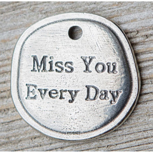 3 of 5:Detailed view of front of key chain and the words