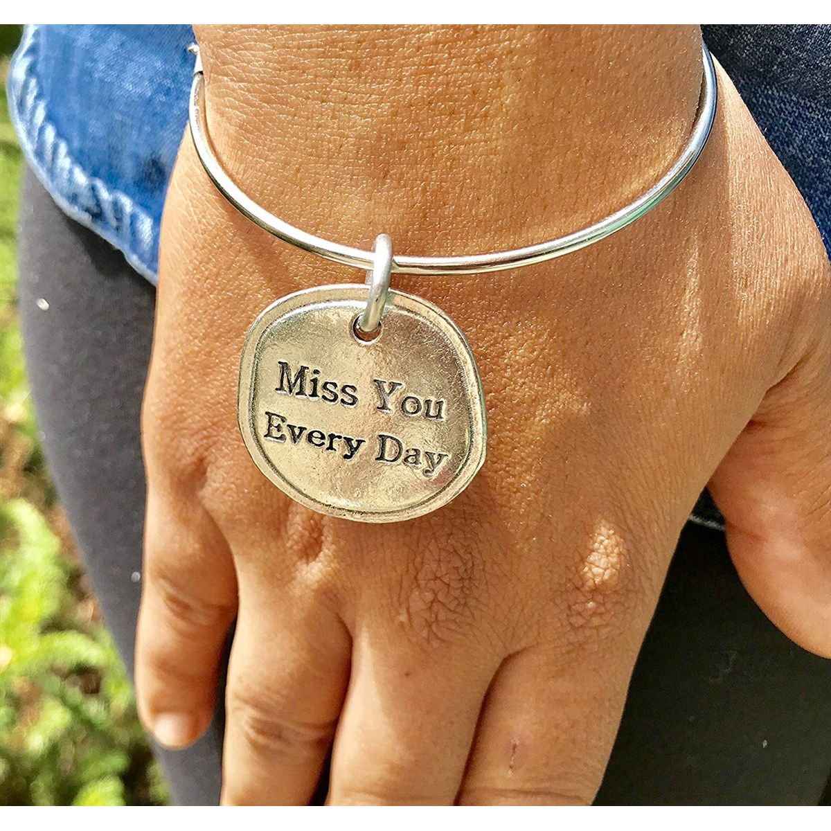 Key chain charm placed on a bracelet.