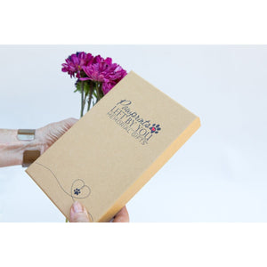 4 of 6:Pet loss gift box being held in hands.