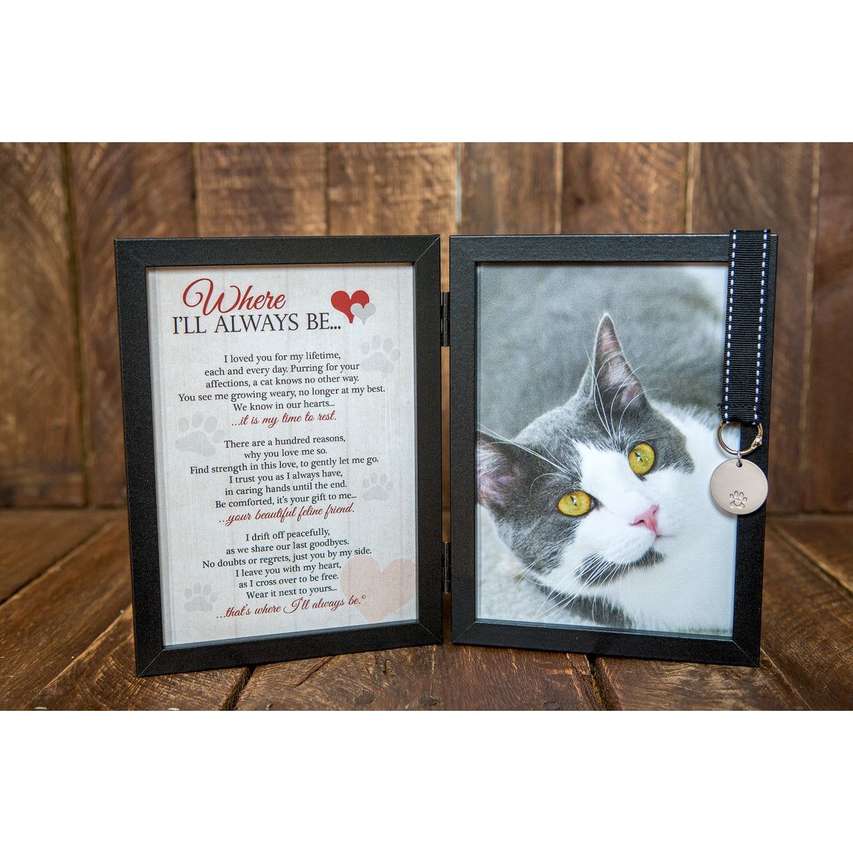 "Where I'll Always Be" frame with stamped pawprint hanging by black grosgrain ribbon with white accents.