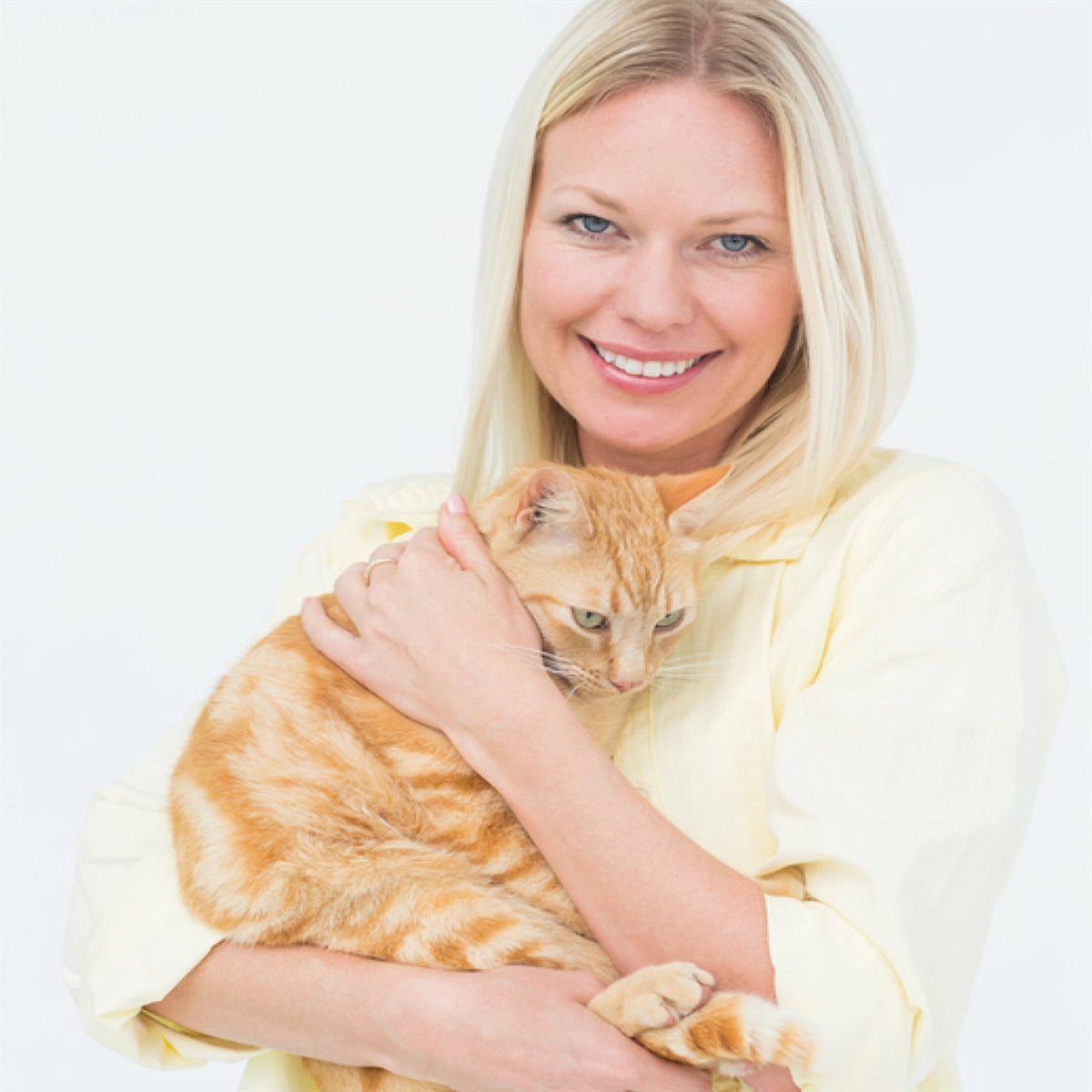 Woman snuggling a cat.