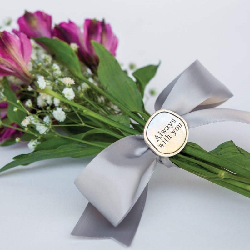 "Always with you" coin on a bouquet.
