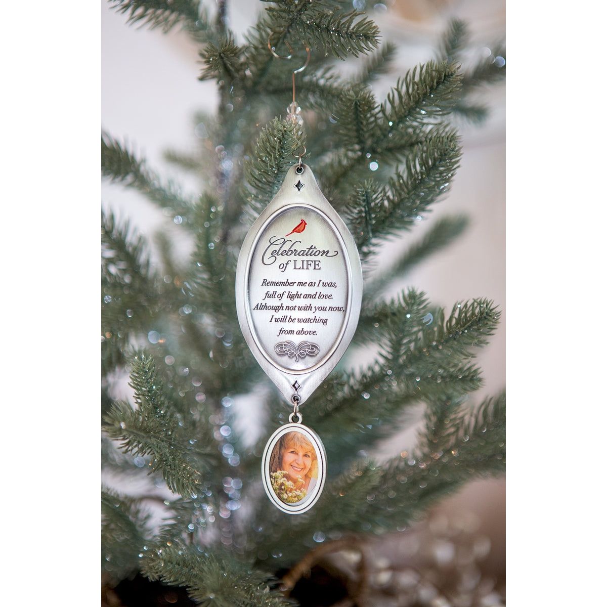 Celebration of Life Ornament hanging from a Christmas tree.