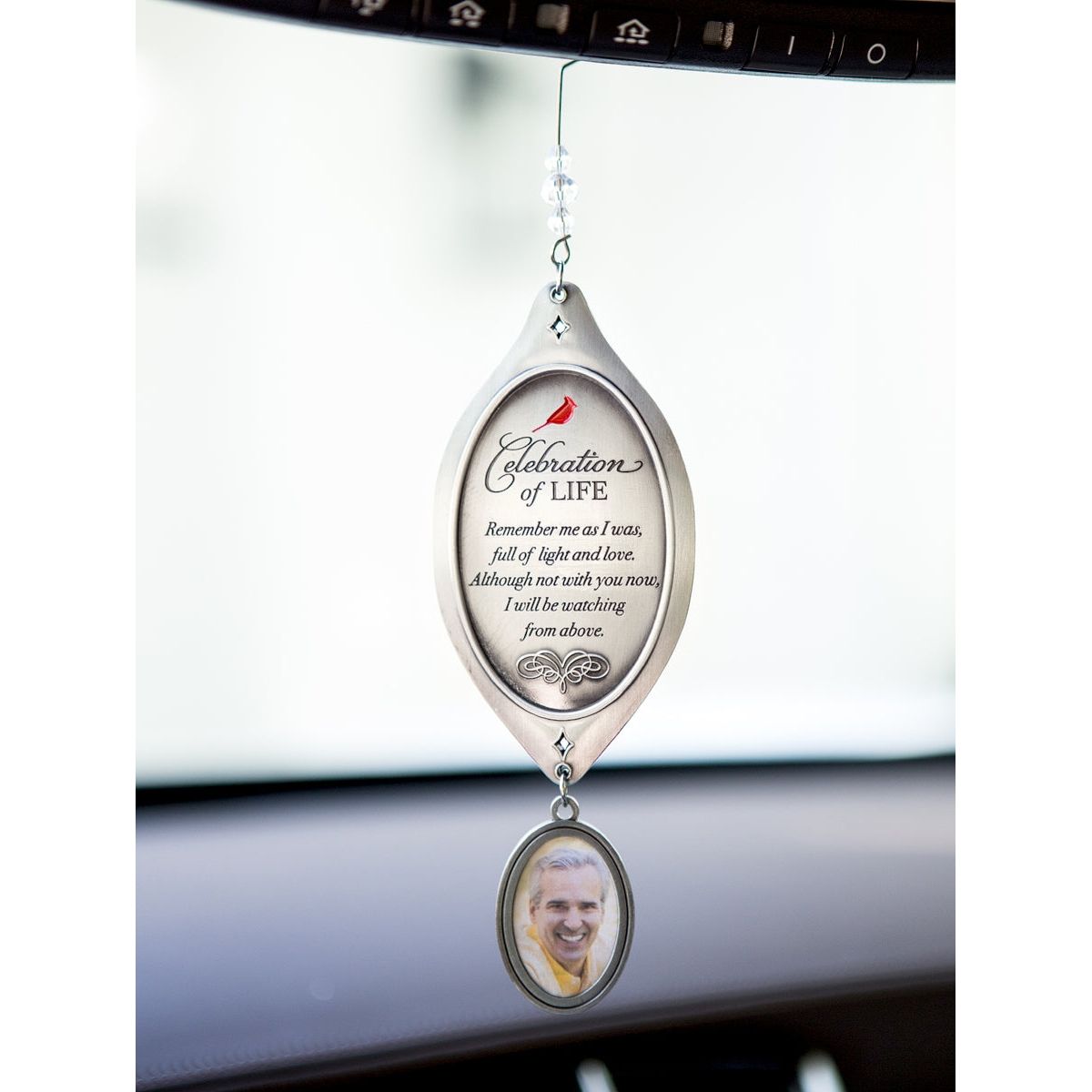 Celebration of Life ornament hanging from a rearview mirror.
