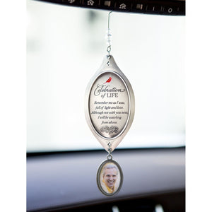 5 of 7:Celebration of Life ornament hanging from a rearview mirror.