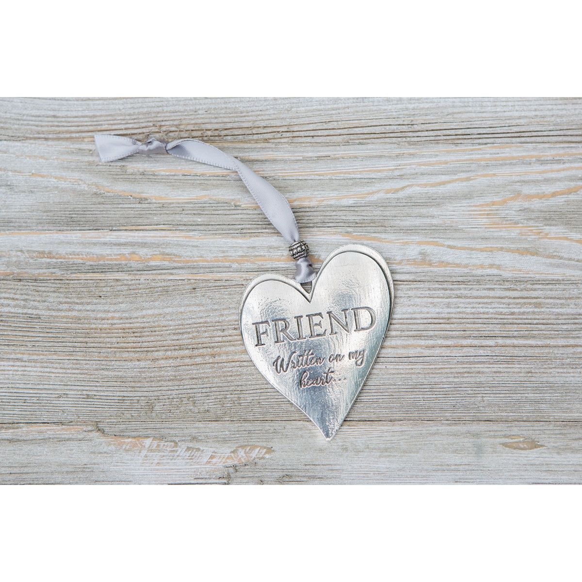 Cast pewter heart engraved with &quot;Friend Written on my heart&quot;.