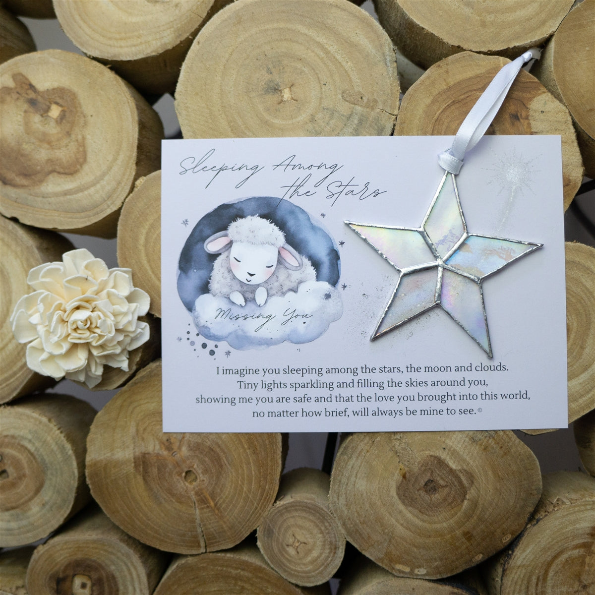 Clear iridescent star with white ribbon and Sleeping Among the Stars poem.