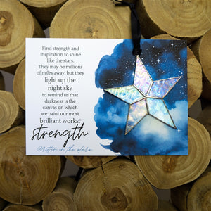 6 of 7:Clear iridescent star and artwork with the