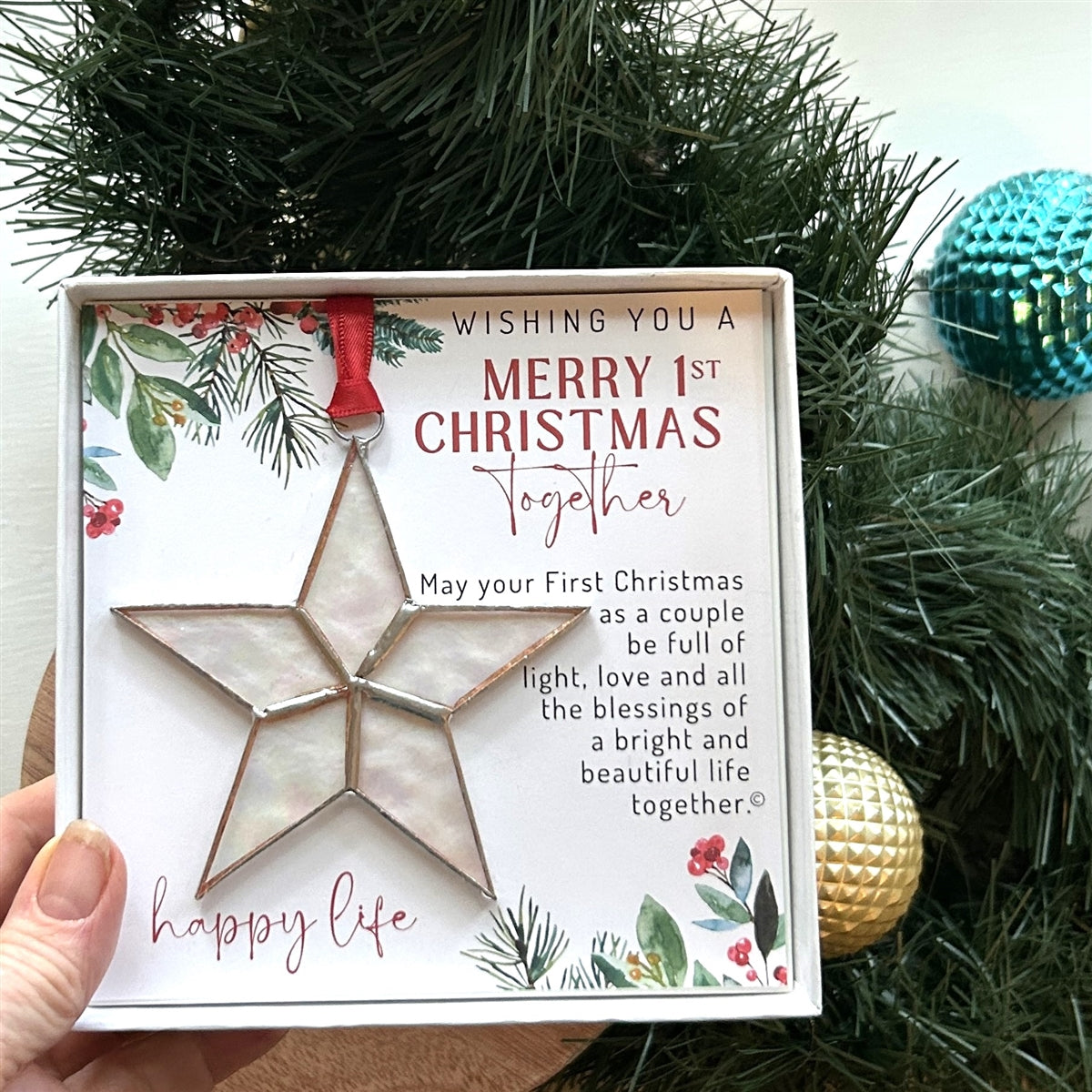 First Christmas Together star ornament boxed in Christmas setting.