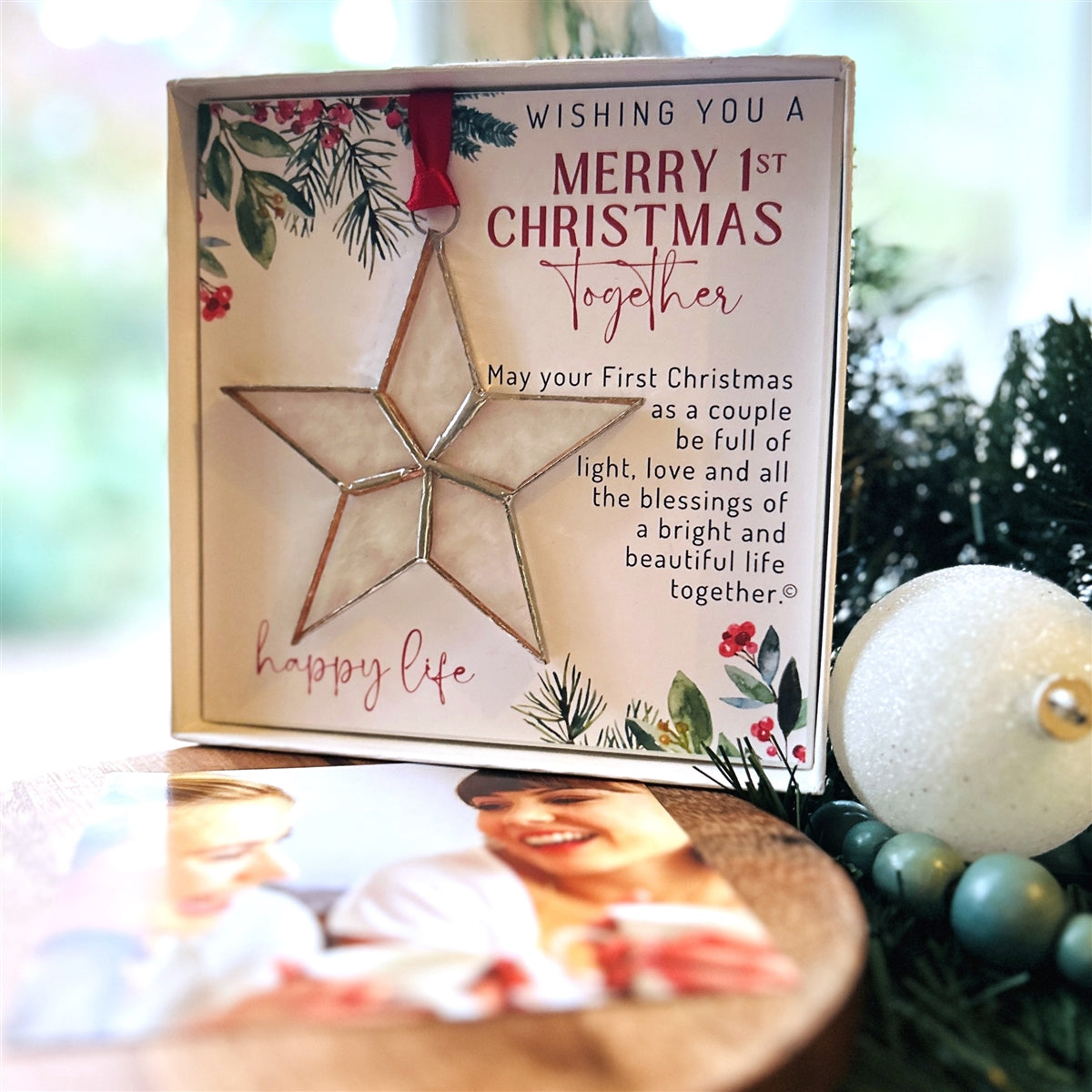 First Christmas Together star ornament boxed with a photo of a laughing happy couple in the foreground.