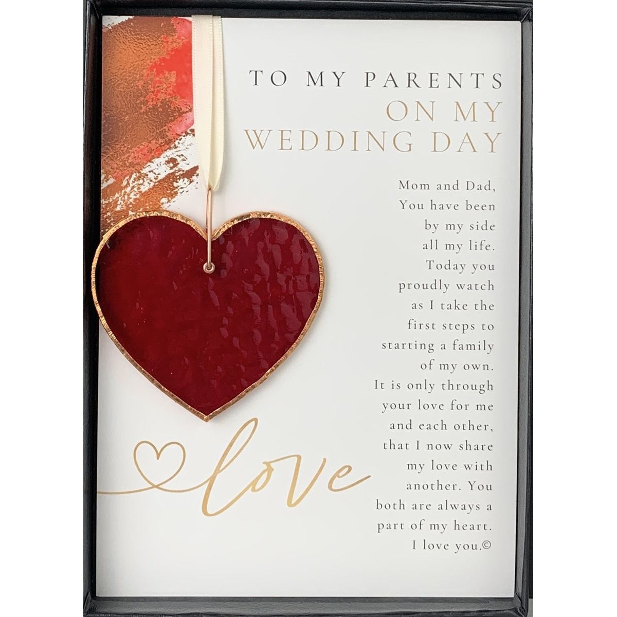 Stained glass red heart edged with copper and packaged with "To My Parents on My Wedding Day" sentiment in black box with clear lid.