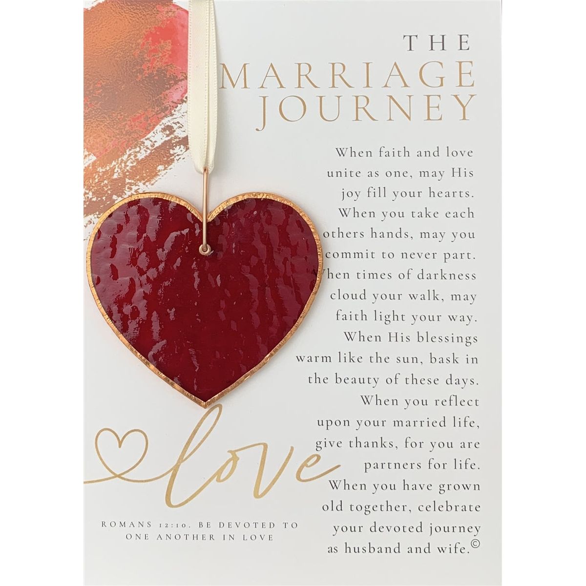 Sentiment and red stained glass heart with the light shining on it to show the texture of the glass.