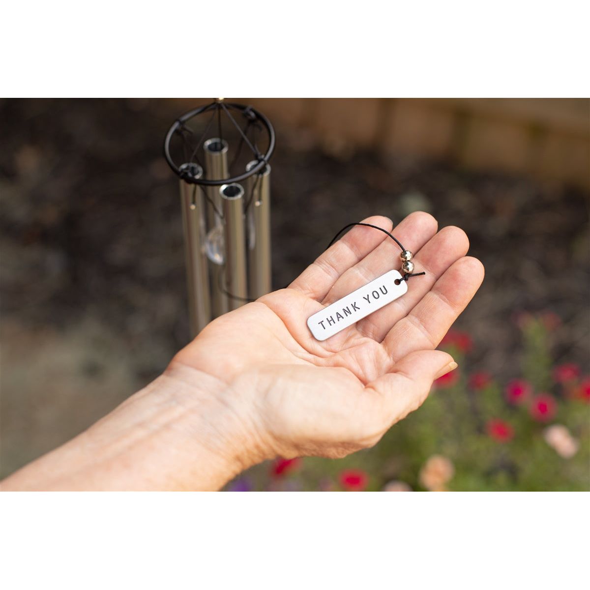 Metal drop pendant with "Thank You" engraved on it.