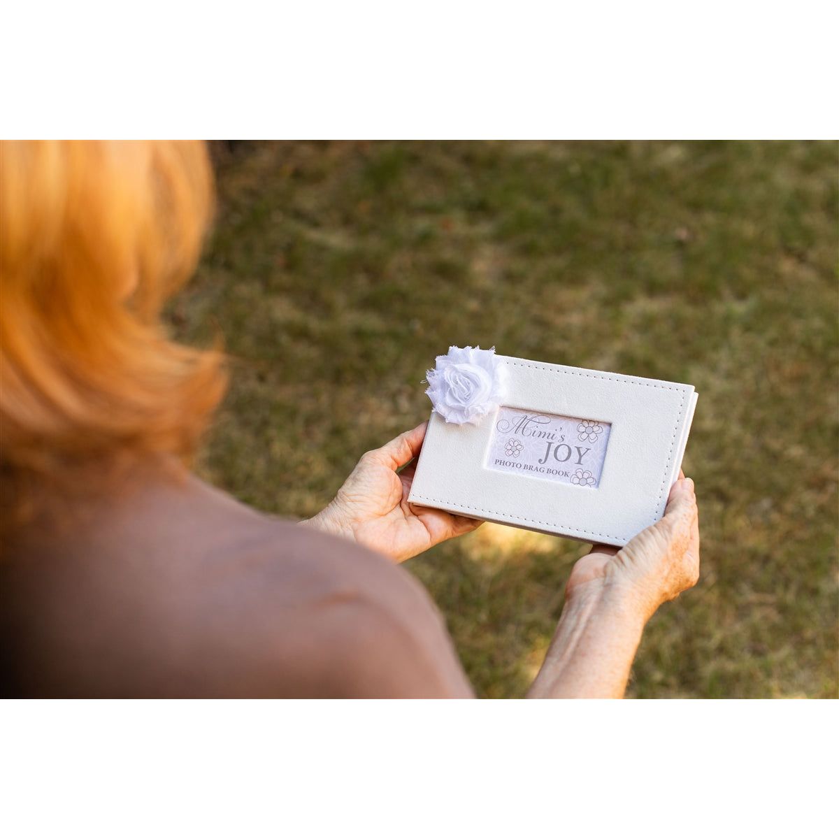 Photo album being held in hands.