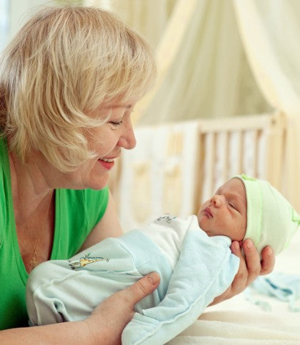 A grandmother holding her grandchild.