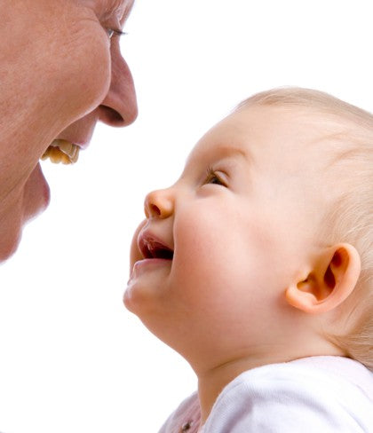 A grandparent and their grandchild laughing.