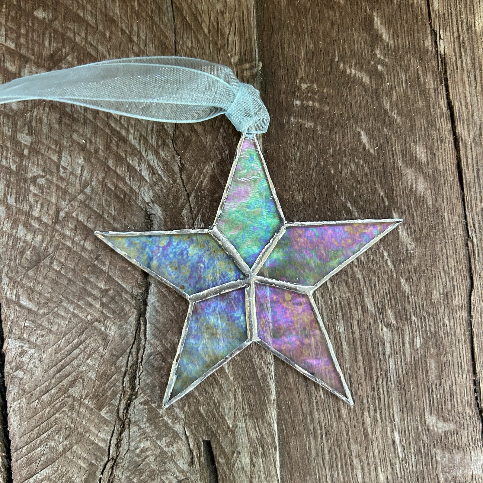 Iridescent glass star laying on a table