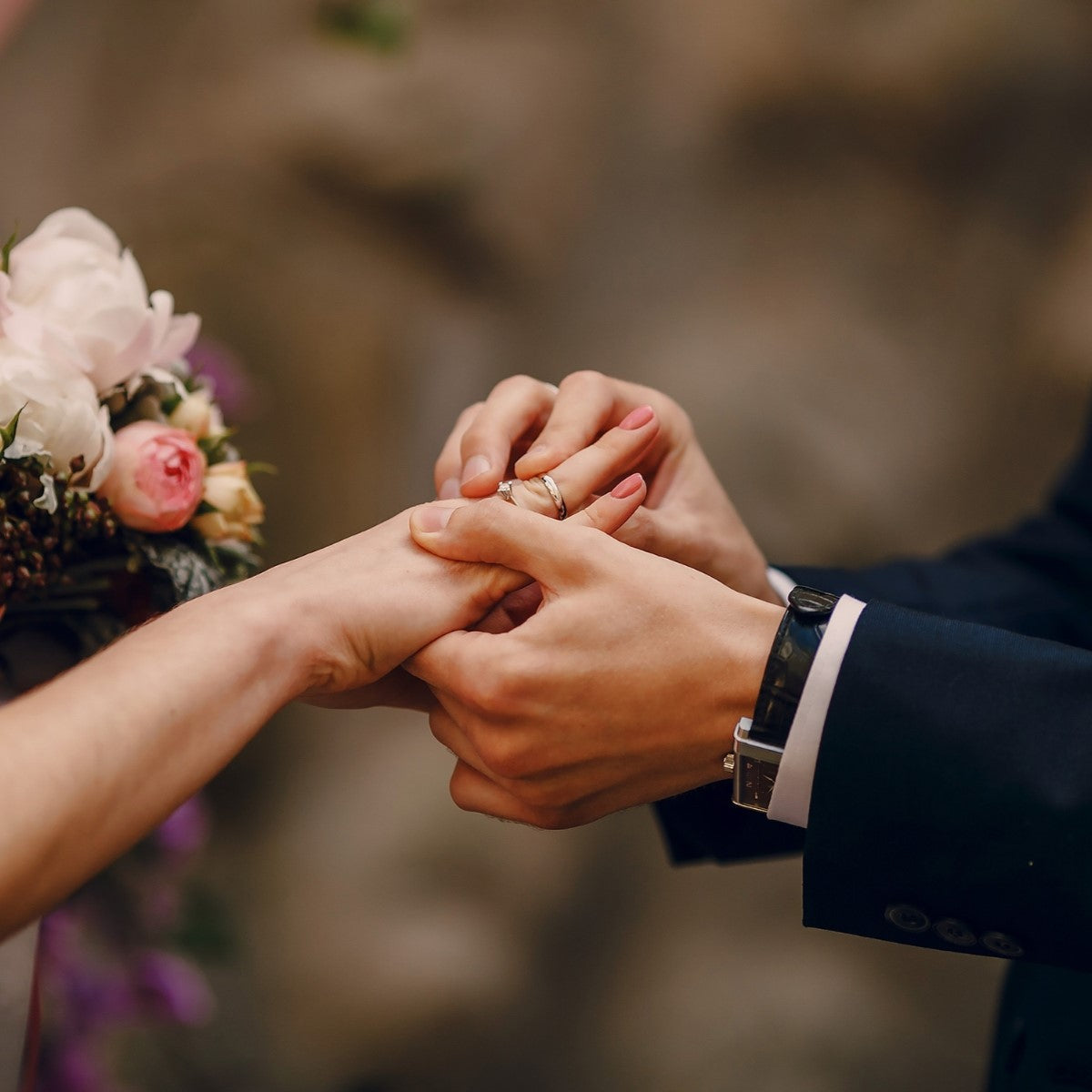 A bride and groom exchanging rings.