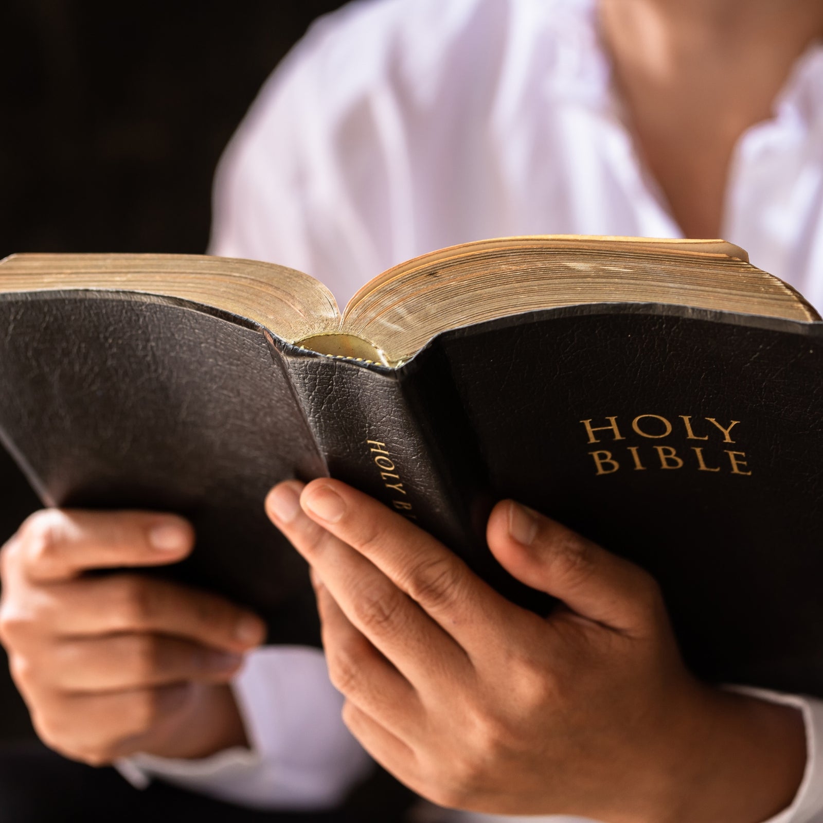 A man holding a bible - Click to shop our Christian and Faith Gifts