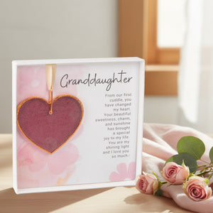 4 of 6:Granddaughter gift on a table by some flowers.